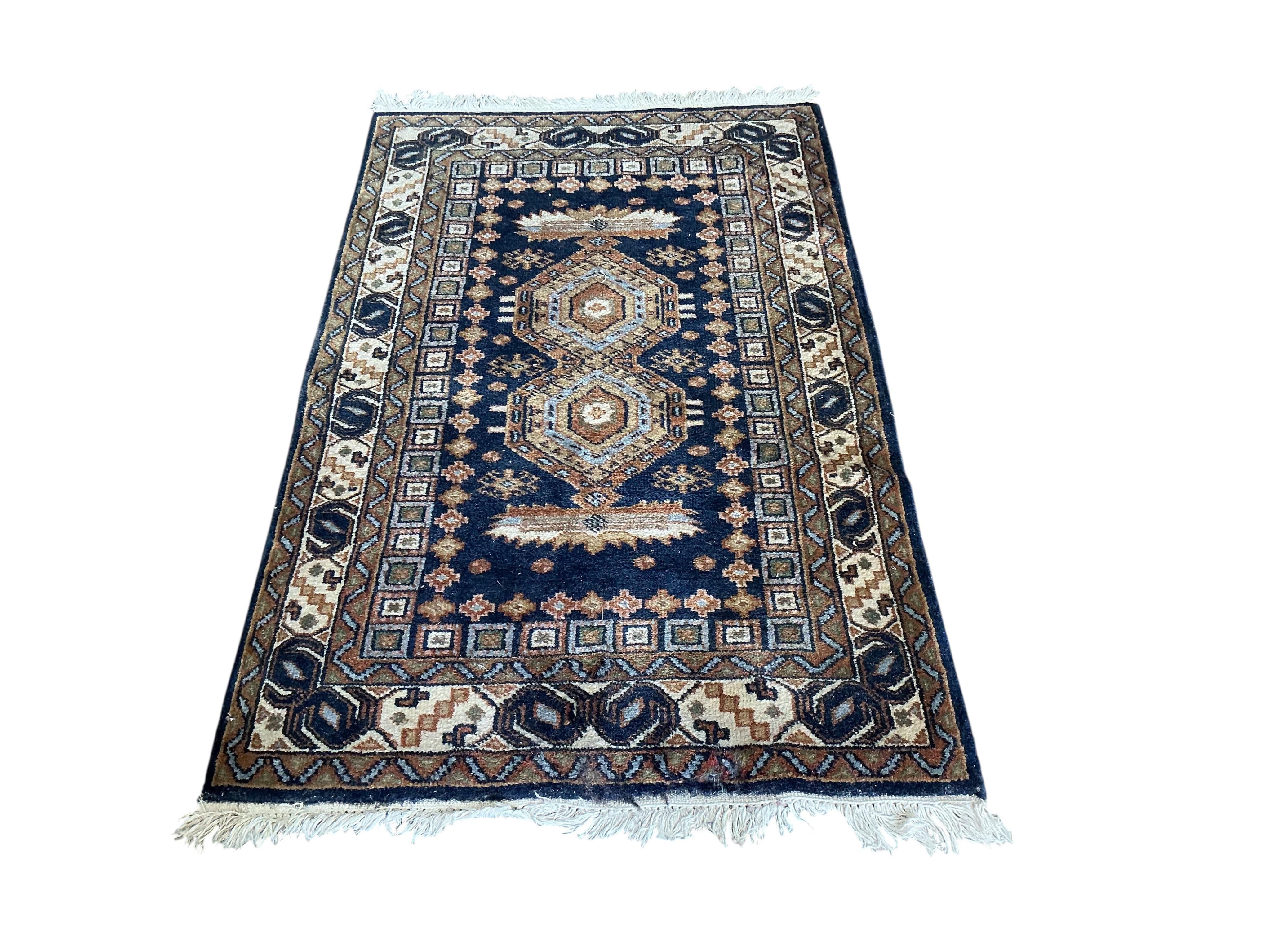 A Bokhara carpet and a smaller Caucasian style rug, larger 290 x 186cm